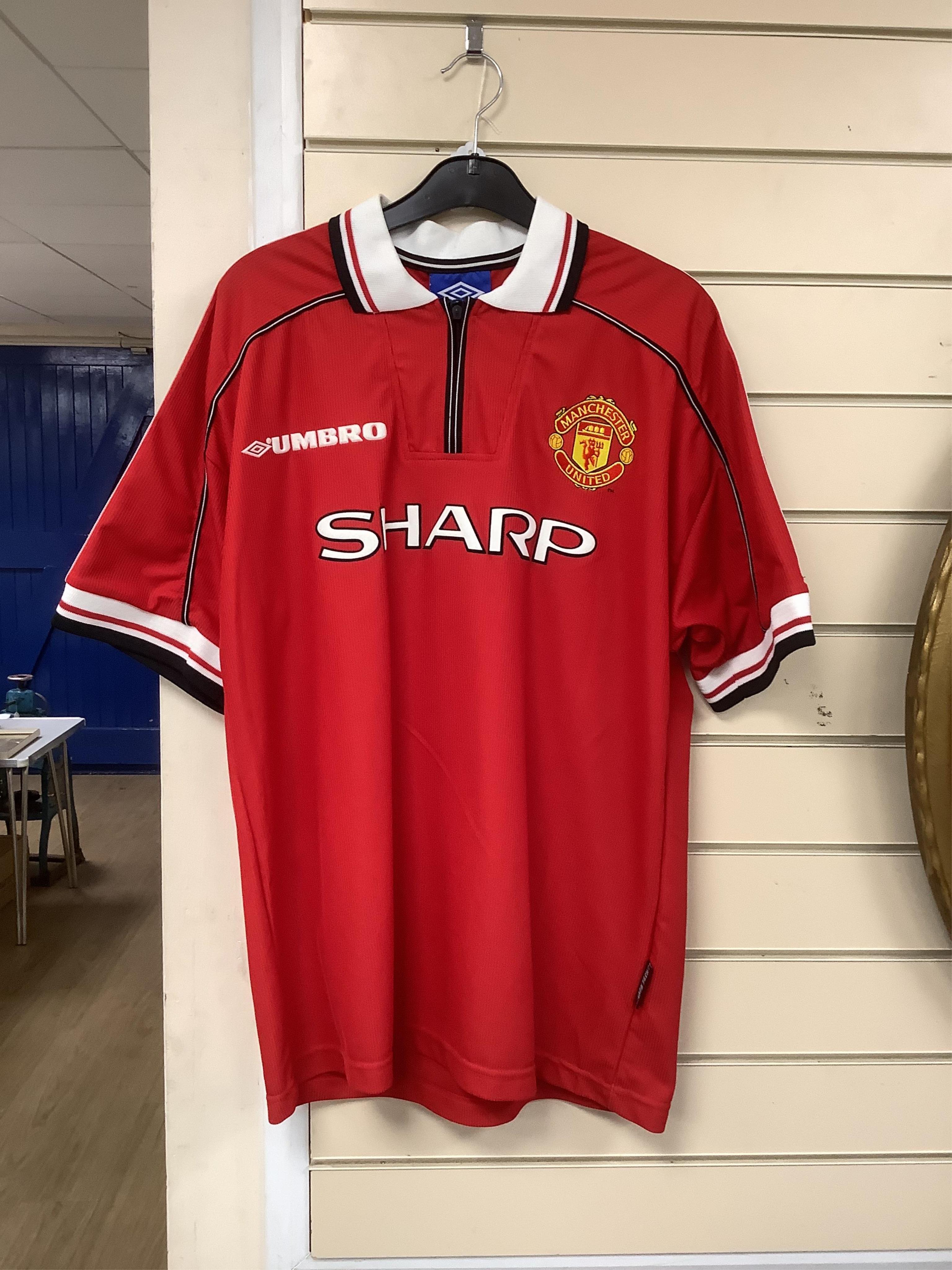 A Manchester United Umbro Sharp polo shirt, signed by David Beckham